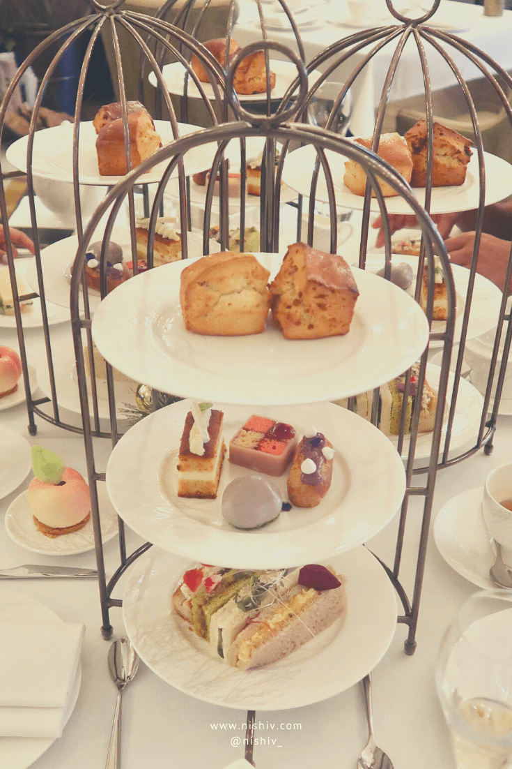 afternoon tea tray with cakes and sandwiches