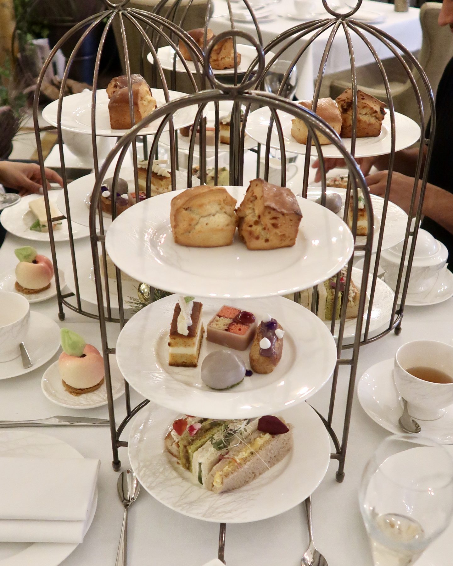 Afternoon Tea, Cocktails & A Tour Of The Langley Hotel Spa, Nishi V. Afternoon tea stand with cakes and sandwiches
