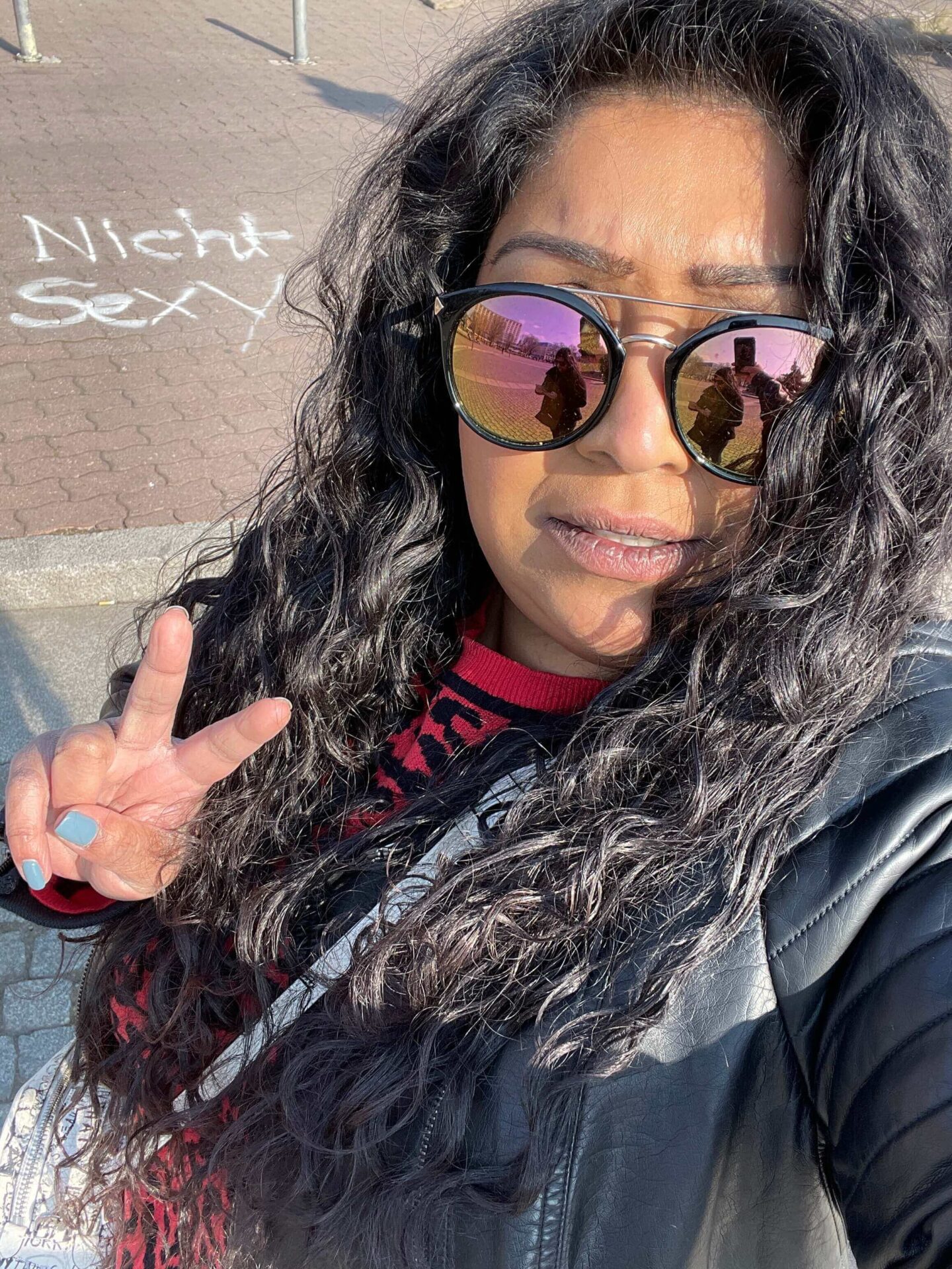 me posing with graffiti that says nicht sexy in berlin