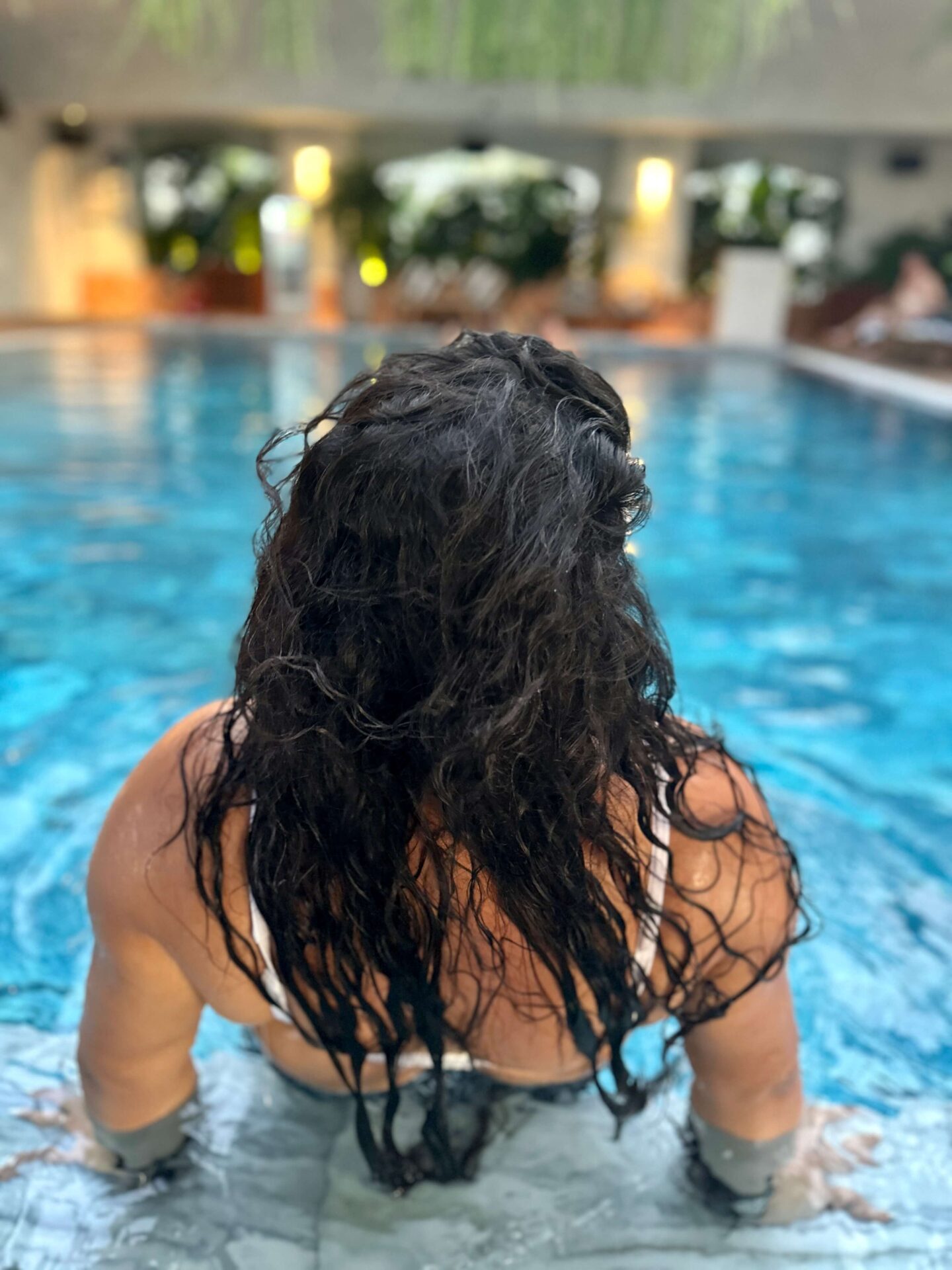 woman in rooftop pool in Saigon
