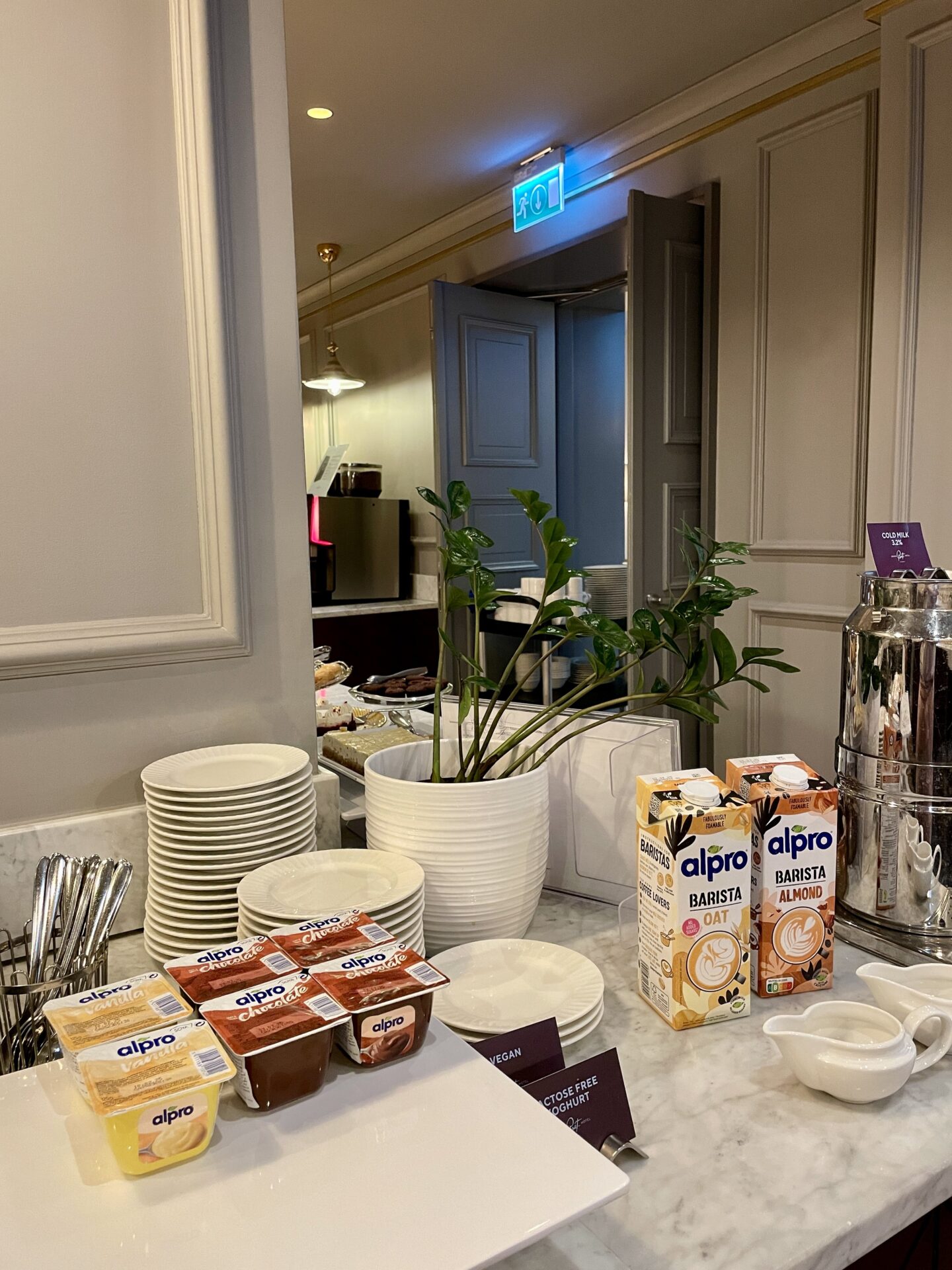 alpro desserts and selection of dairy free milk at a breakfast buffet