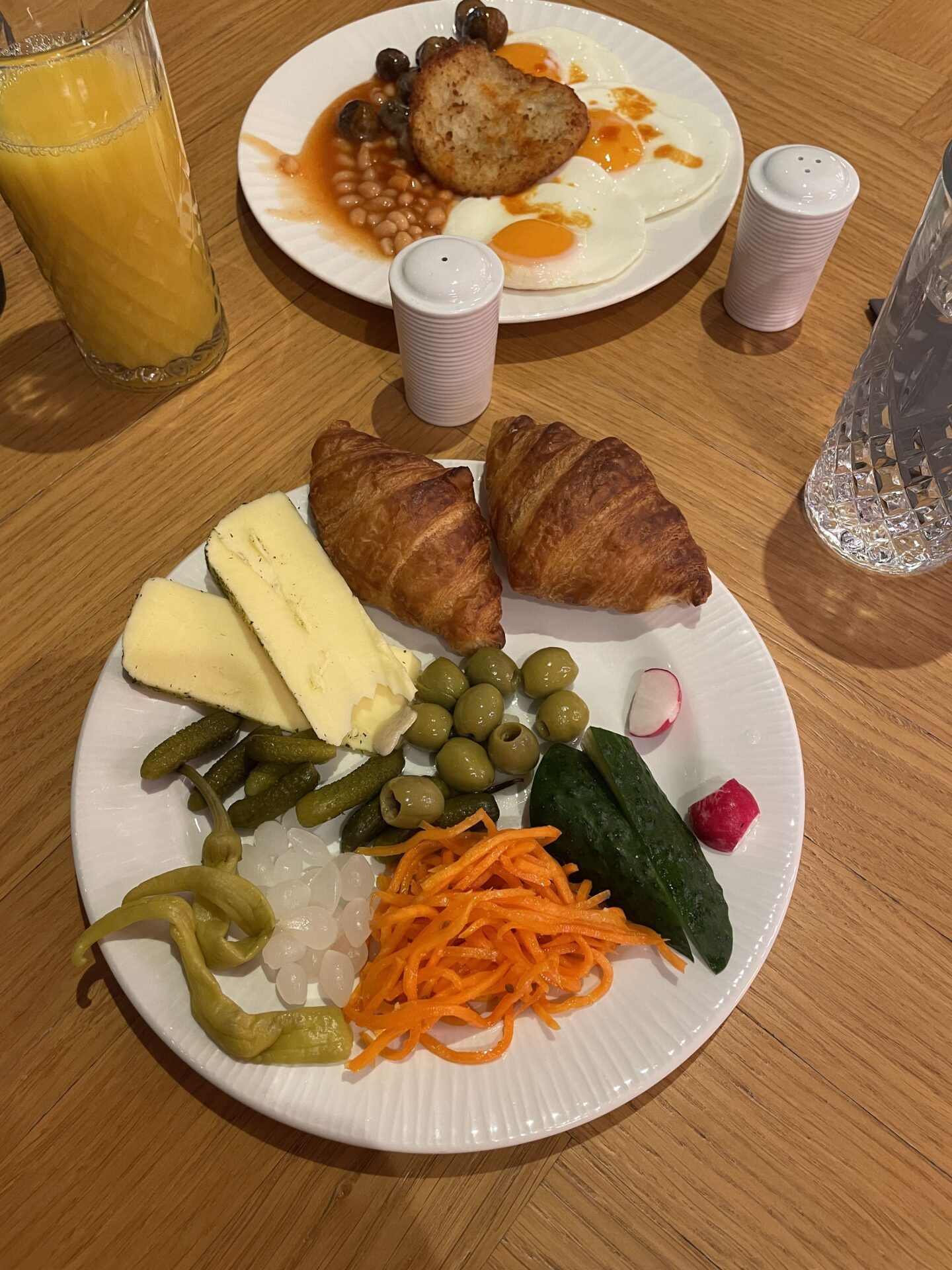continental breakfast with 2 mini croissants, cheese, cucumber, olives, pickled carrots, pickled onions and chillies