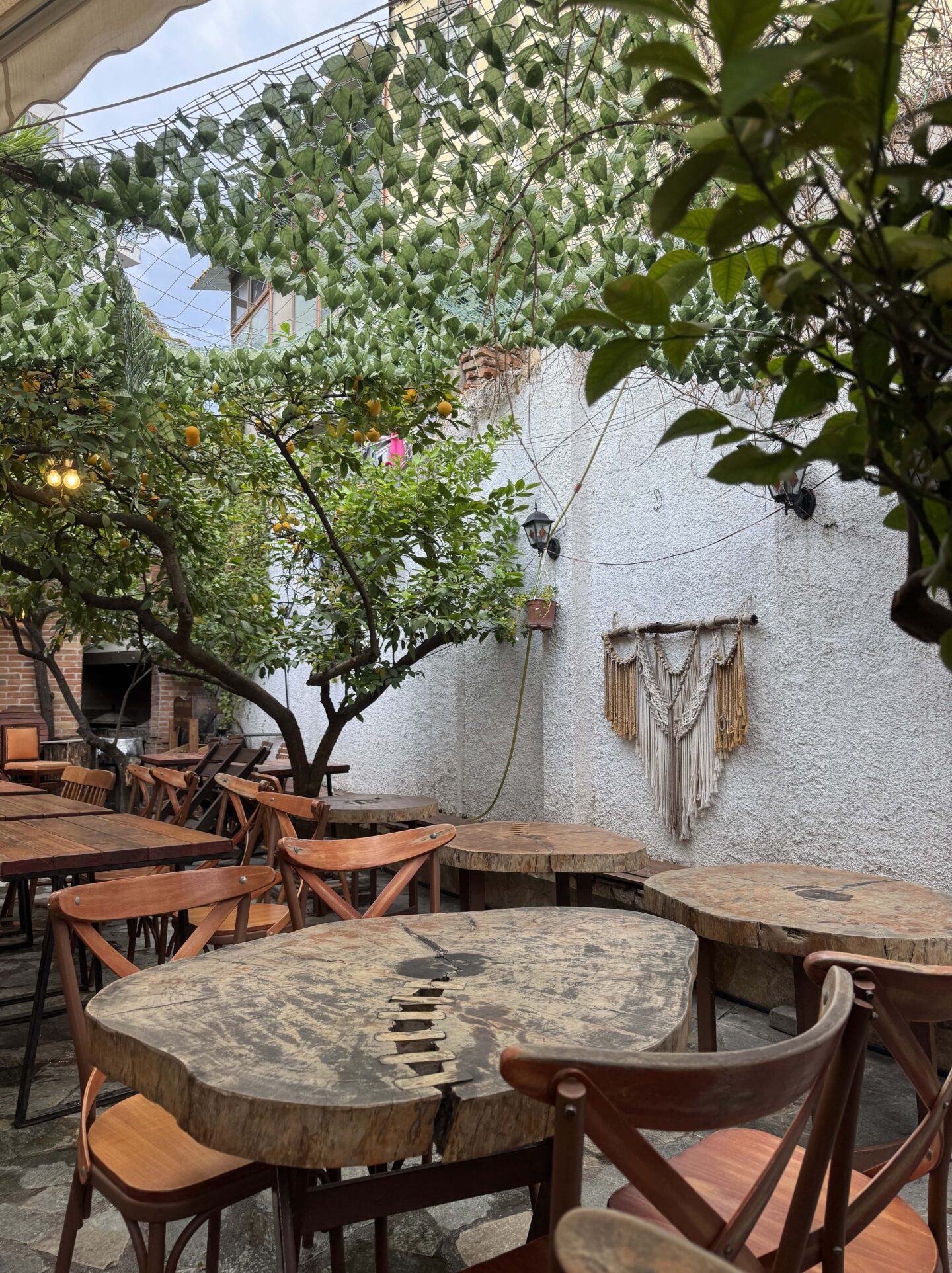 rustic wooden table outdoors at Oda Traditional Albanian Restaurant in Tirana