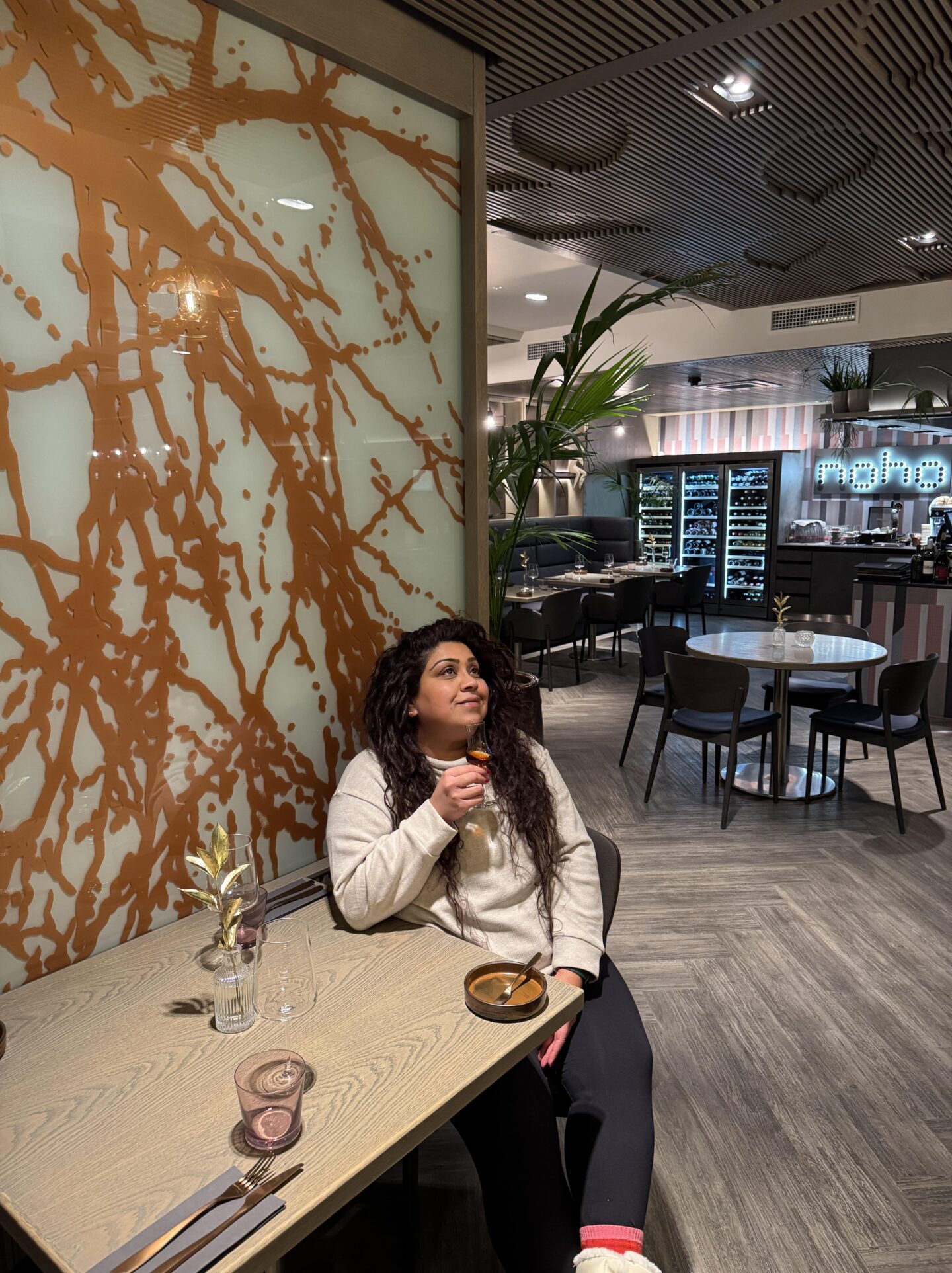 Nishi drinking Vana Tallinn at Noho restaurant inside Nordic Hotel Forum