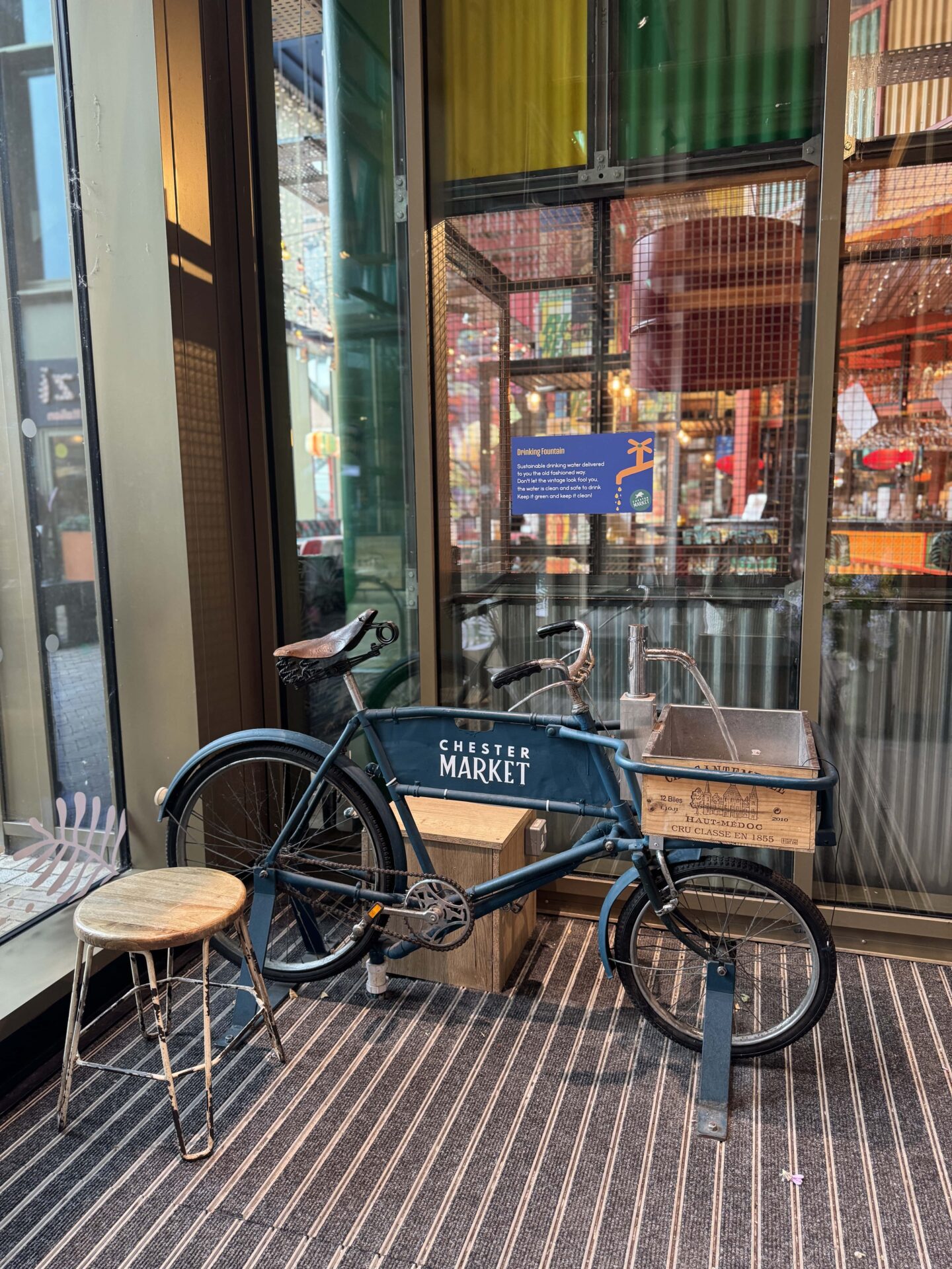 quirky water refill station on a blue bicycle with a tap attached to the handlebars