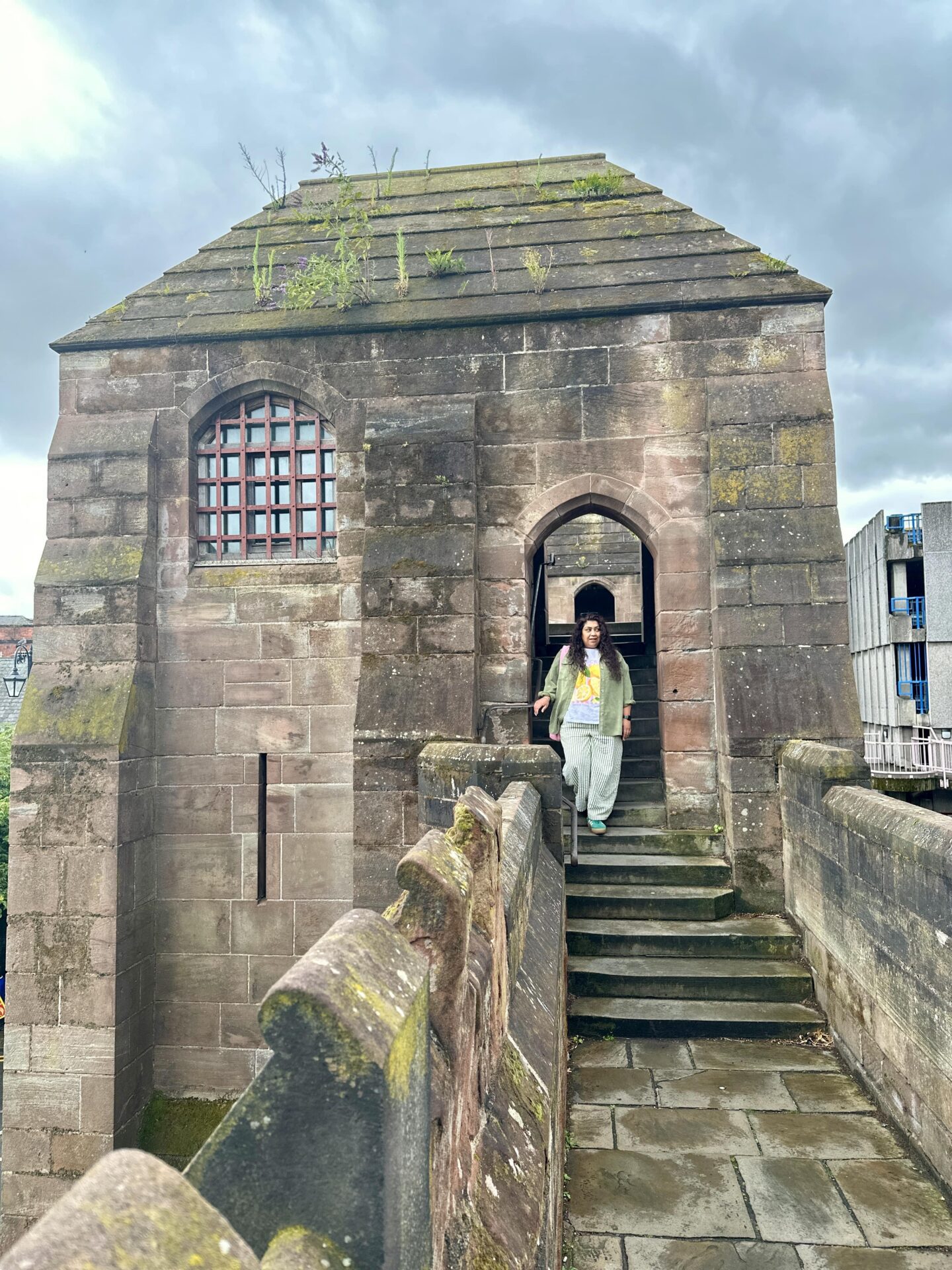 Nishi walking down some steps on Chester City Walls