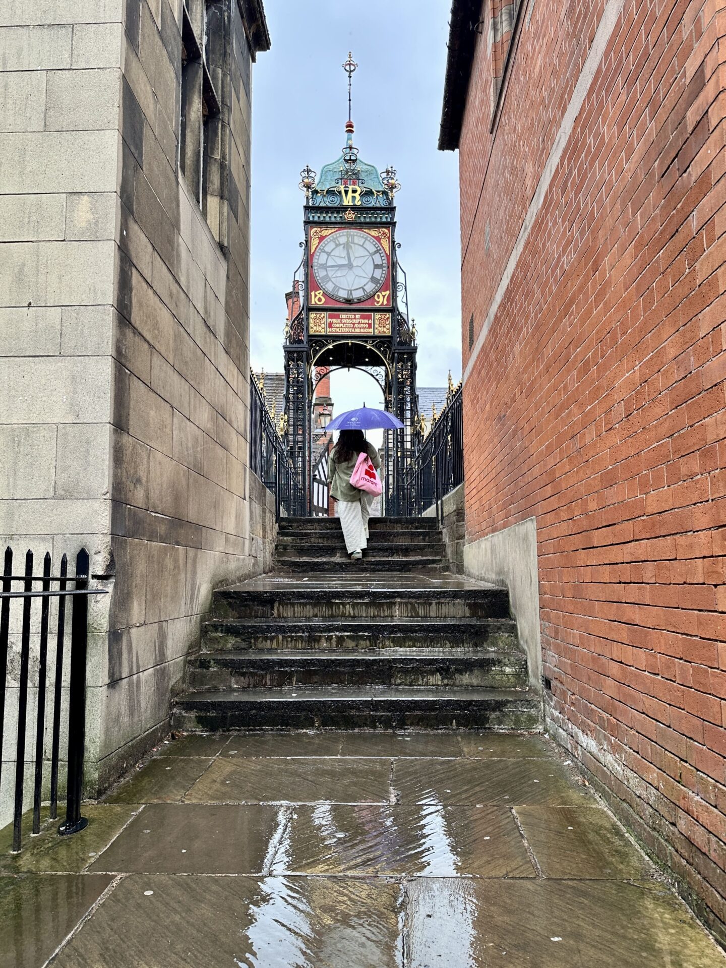 Nishi walking up the steps to Eastgate clock in Chester