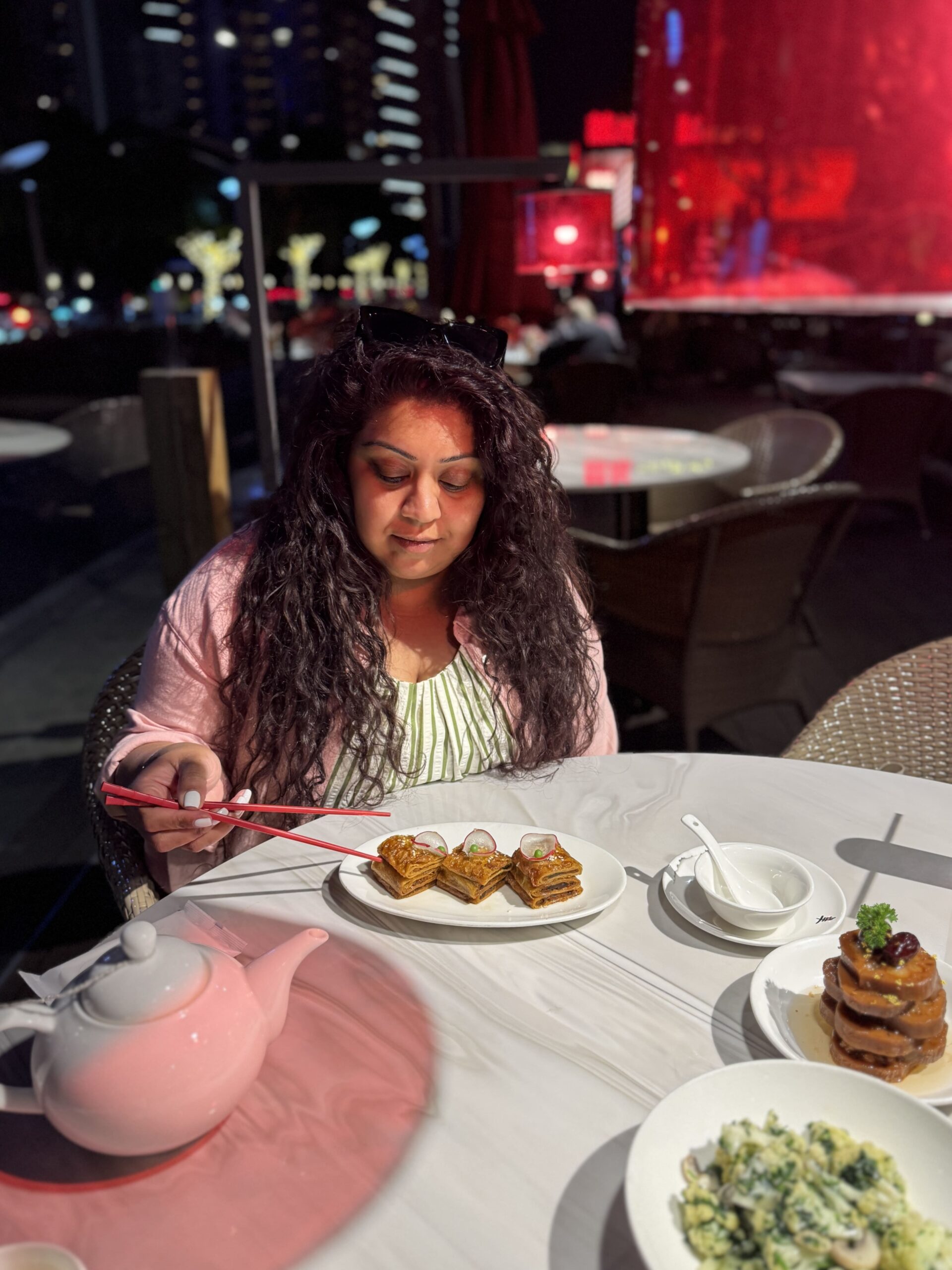 Nishi eating vegetarian chinese food with chopsticks in Shanghai
