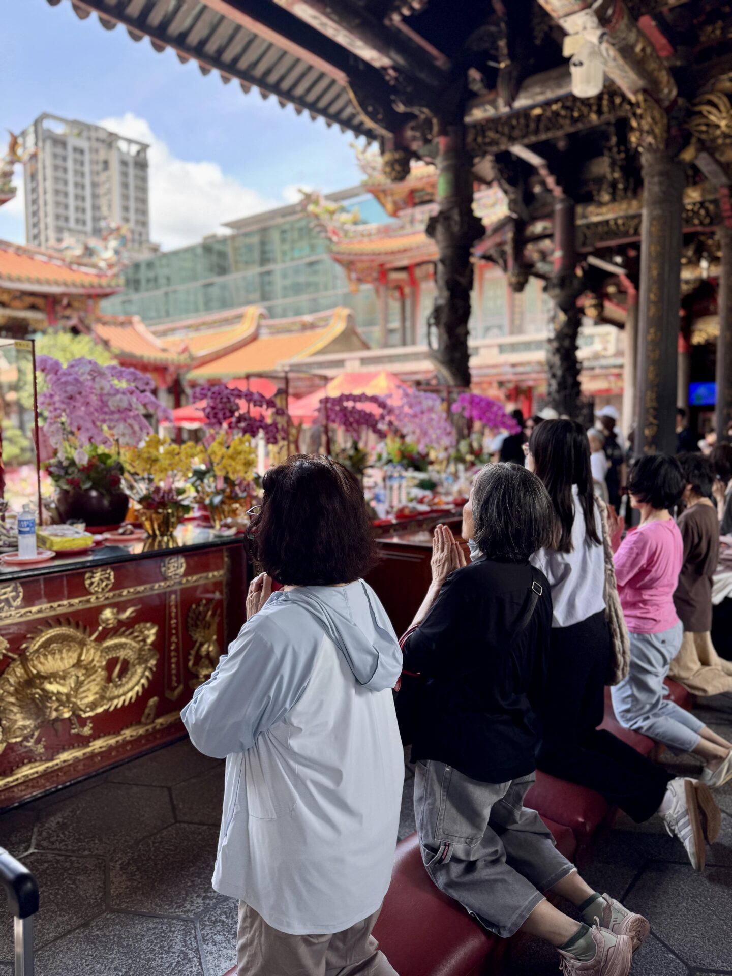 women praying at Longshan Temple in Taipei