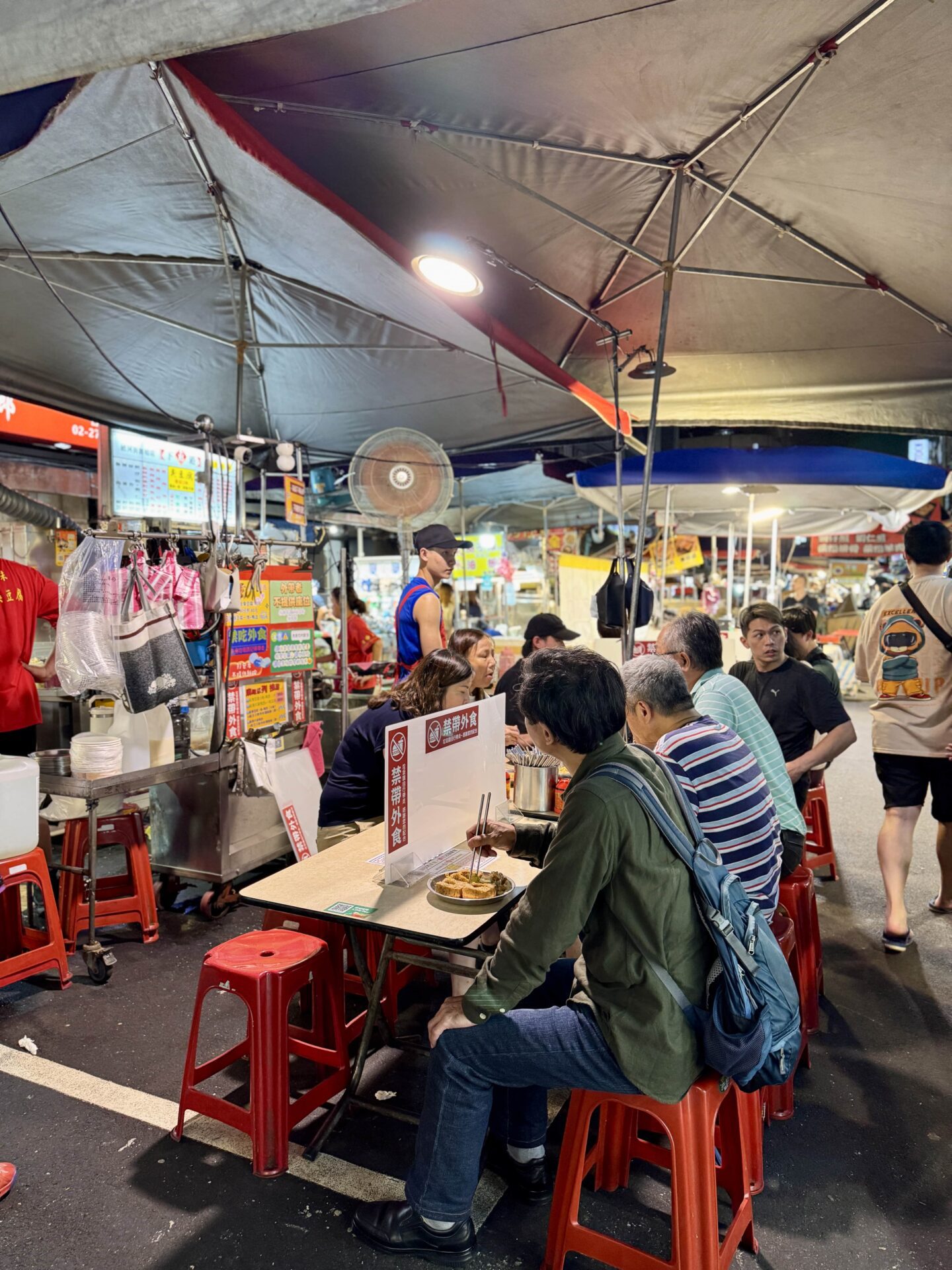 locals eating at Raohe Street Night Market in Taipei