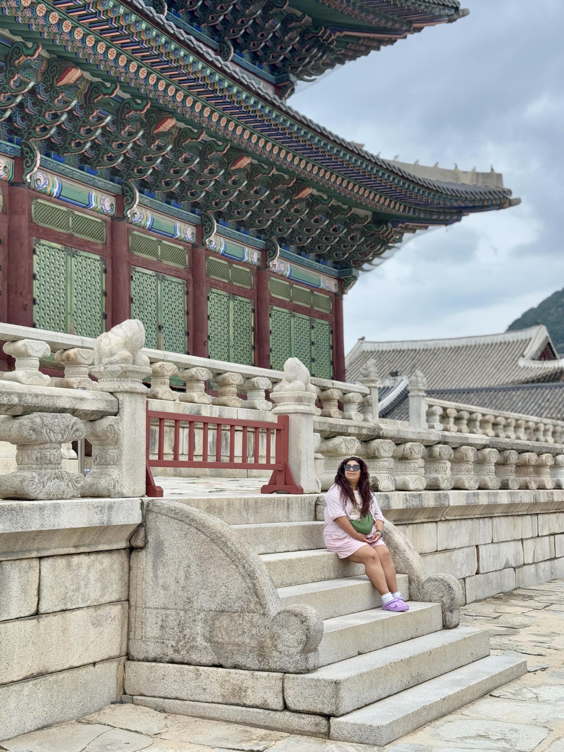 Nishi sat on the steps inside Gyeongbokgung Palace Seoul