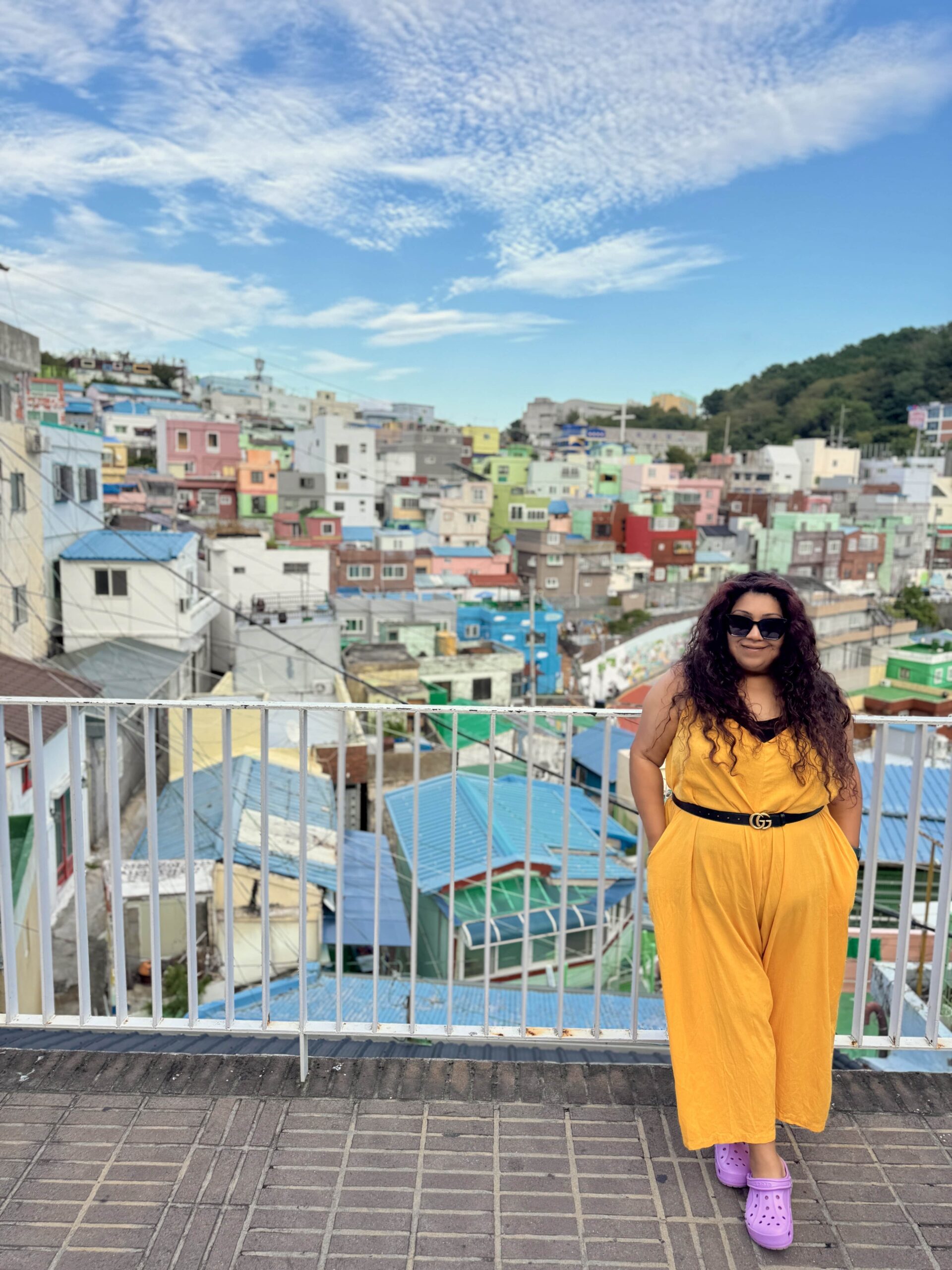 Nishi standing with the view of Gamcheon Culture Village behind her